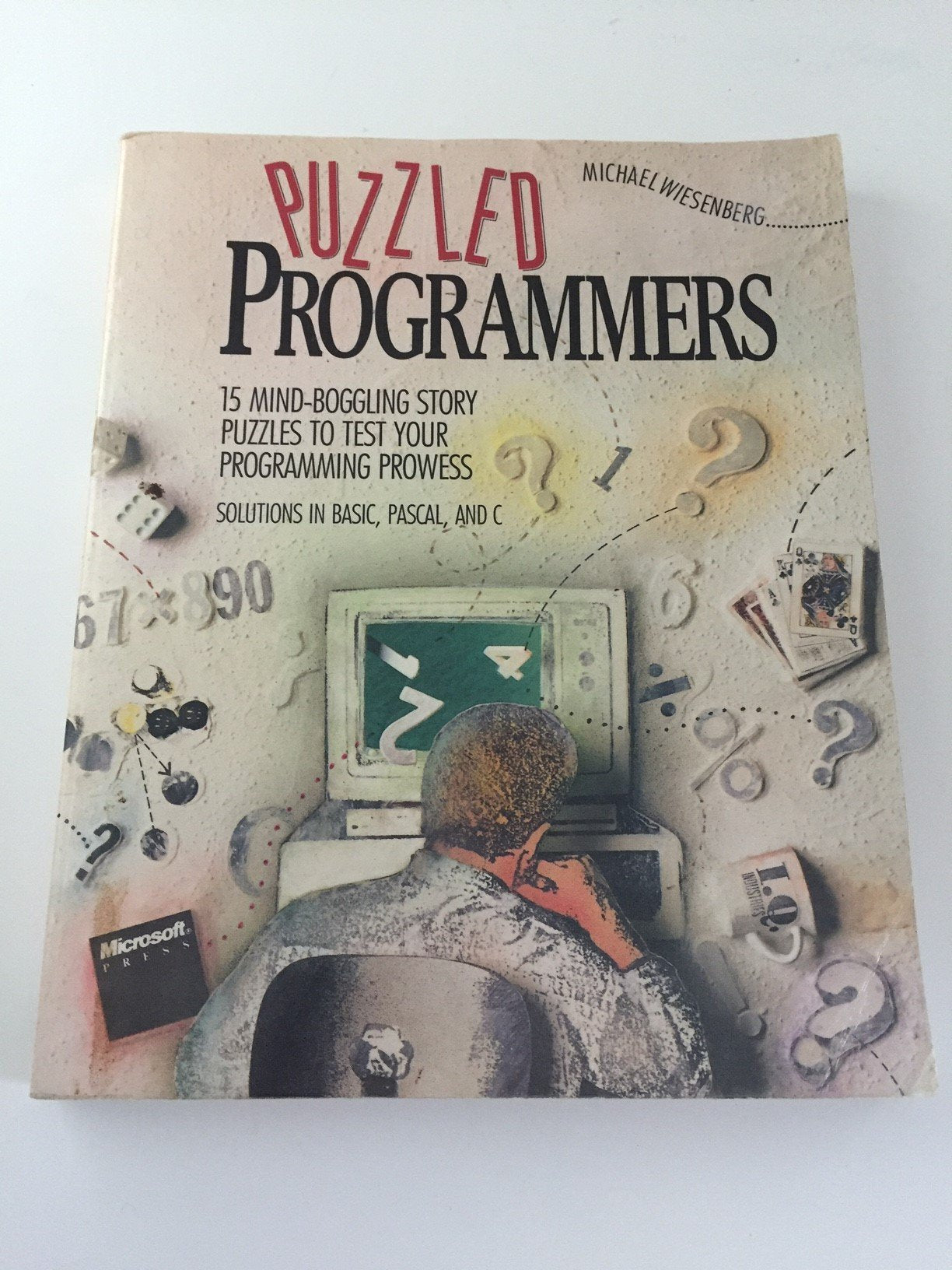 Puzzled Programmers: 15 MindBoggling Story Puzzles to Test Your Programming Prowess : Solutions in Basic, Pascal, and C,Used